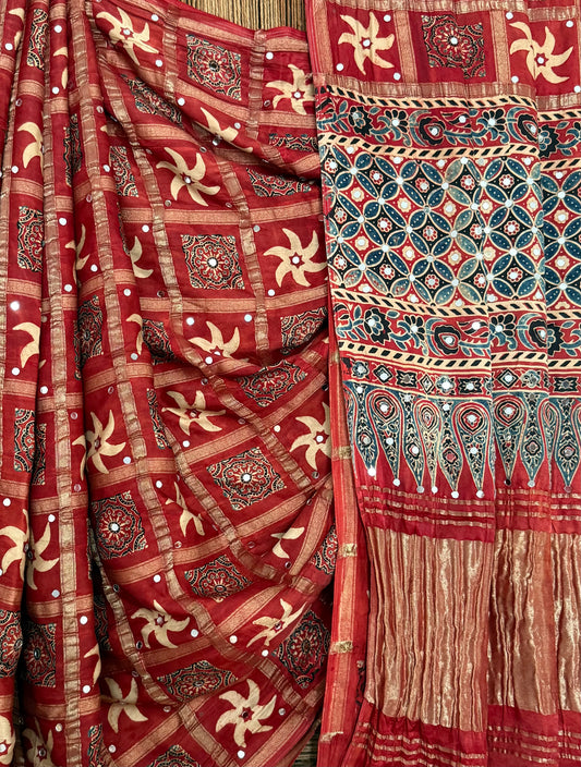 CLASSIC MAROON AJRAKH HANDCRAFTED MIRROR WORK (PASTING)GHARCHOLA MODAL SILK SARI WITH ZARI PALLU