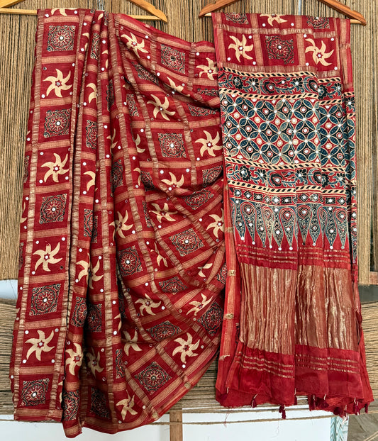 CLASSIC MAROON AJRAKH HANDCRAFTED MIRROR WORK (PASTING)GHARCHOLA MODAL SILK SARI WITH ZARI PALLU