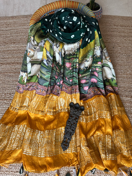 DARK GREEN MODAL SILK BANDHANI DUPATTA WITH PICHWAI PRINT IN NAKSHI BORDER